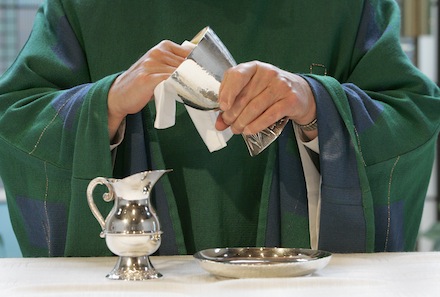 PHOTO ILLUSTRATION SHOWS PRIEST CLEANING COMMUNION VESSELS