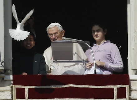 Benedict XVI releases a dove during yesterday's Angelus address (AP)